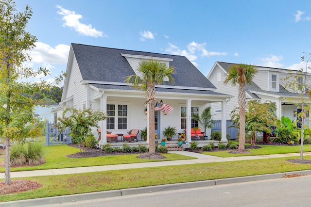 view of front of home featuring covered porch and a front lawn