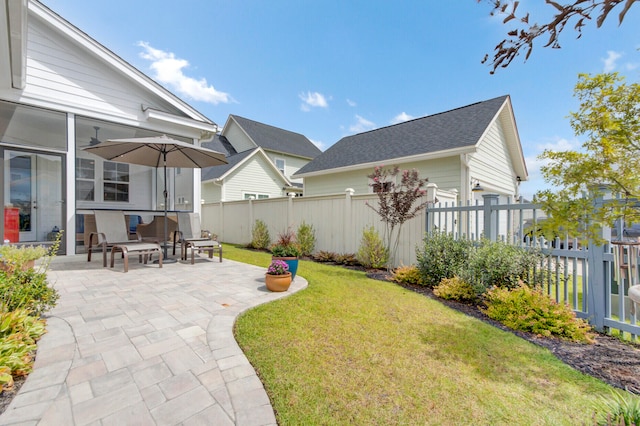 view of yard featuring a patio area and a sunroom