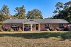 ranch-style home featuring a front yard