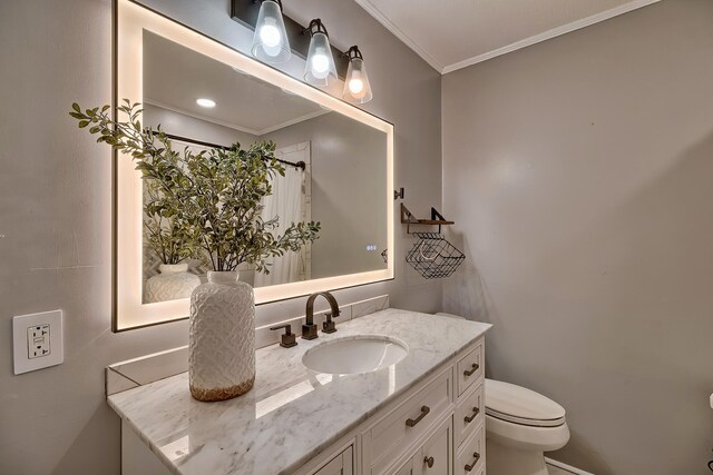 bathroom with vanity, toilet, and crown molding