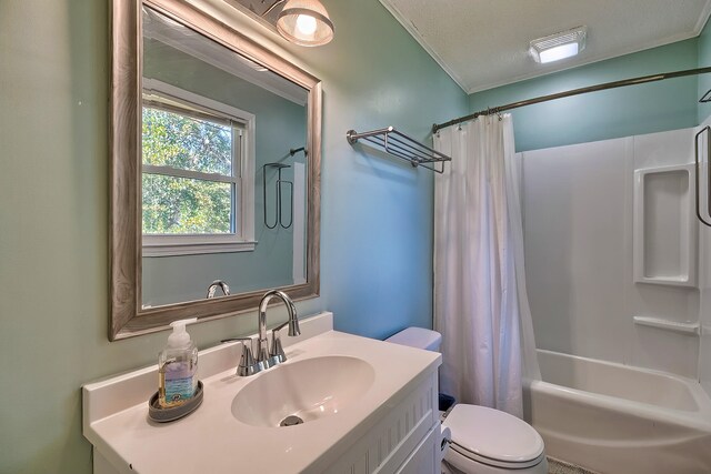 full bathroom with ornamental molding, a textured ceiling, shower / bathtub combination with curtain, vanity, and toilet