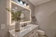 bathroom with vanity and toilet