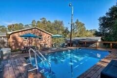 view of swimming pool with a deck