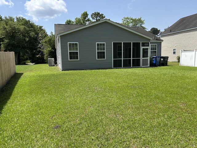 back of property with cooling unit and a sunroom
