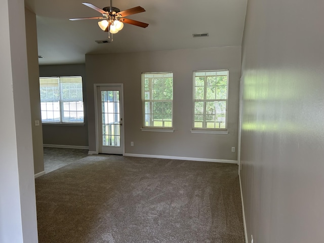 empty room featuring carpet, baseboards, and a ceiling fan