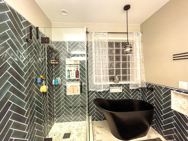 6212 Fieldstone Cir, Charleston, SC 29414 - bathroom with tile walls, tiled shower, and wainscoting