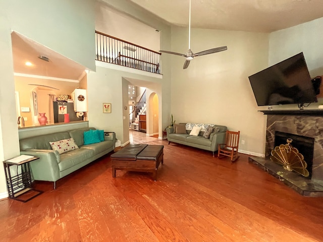 6212 Fieldstone Cir, Charleston, SC 29414 - living room featuring arched walkways, wood finished floors, baseboards, a fireplace, and high vaulted ceiling