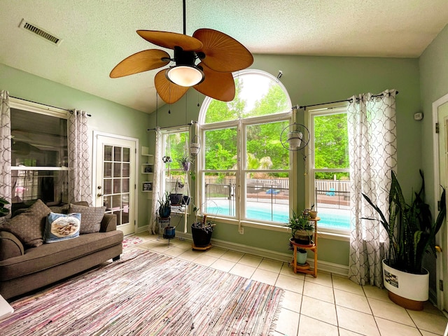 6212 Fieldstone Cir, Charleston, SC 29414 - sunroom featuring tile patterned floors, vaulted ceiling, healthy amount of natural light, a textured ceiling, and baseboards