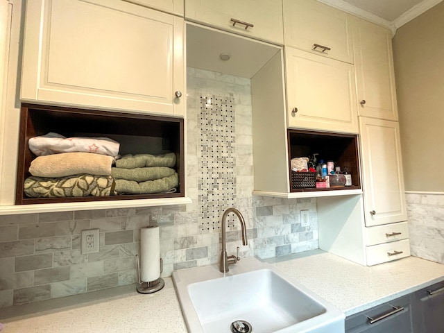 6212 Fieldstone Cir, Charleston, SC 29414 - kitchen featuring open shelves, a sink, ornamental molding, tasteful backsplash, and light stone counters