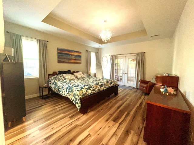 6212 Fieldstone Cir, Charleston, SC 29414 - bedroom featuring french doors, a raised ceiling, wood finished floors, access to outside, and baseboards