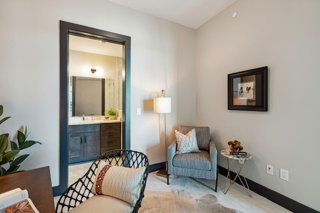 sitting room with light colored carpet and baseboards