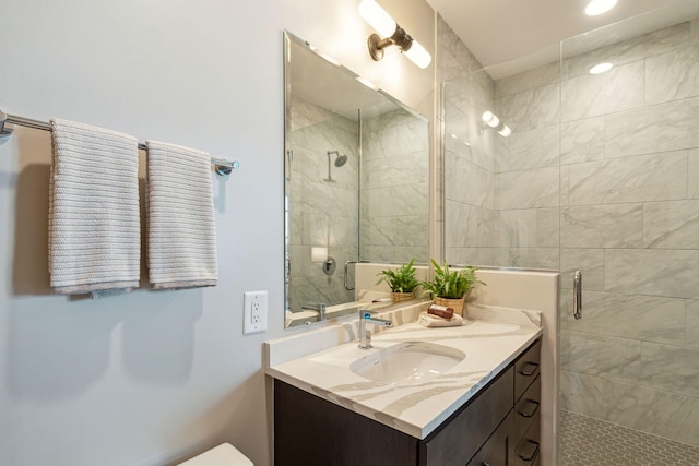 full bathroom with a stall shower and vanity