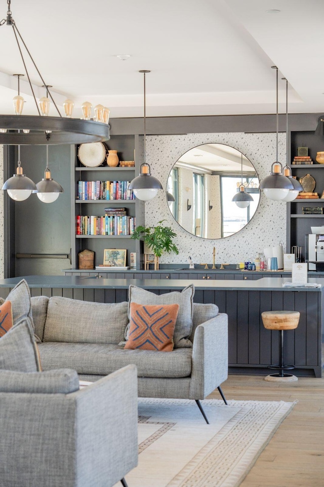 living room with light wood-type flooring and arched walkways