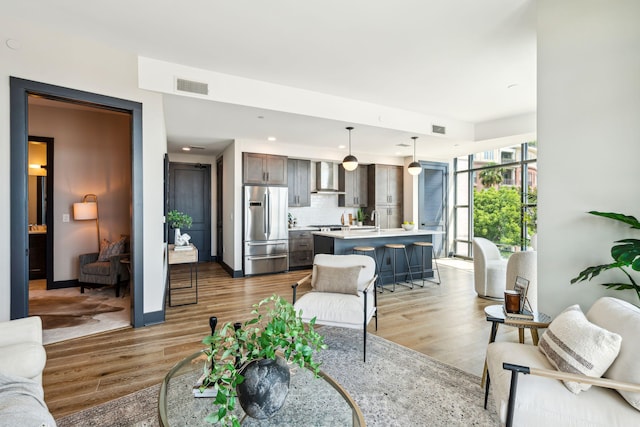 living area with wood finished floors and recessed lighting