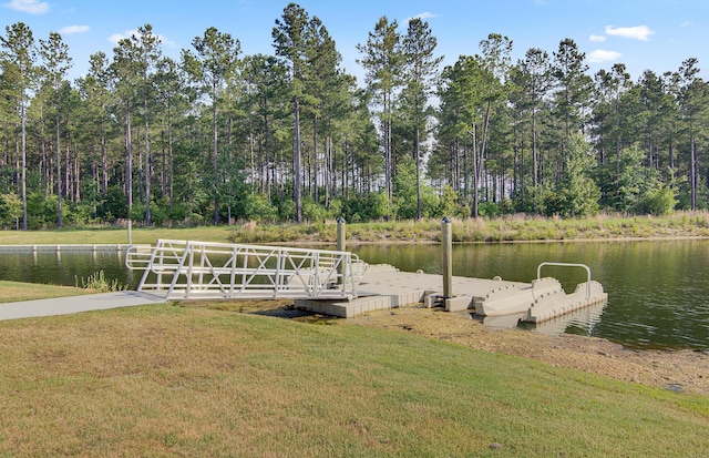 view of dock featuring a lawn and a water view