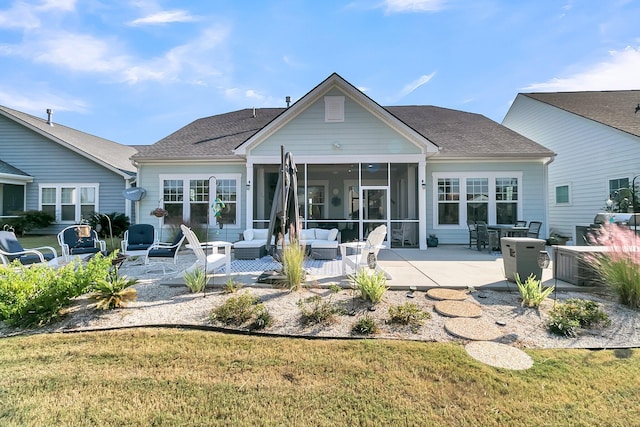 back of house featuring a patio, a sunroom, outdoor lounge area, and a yard