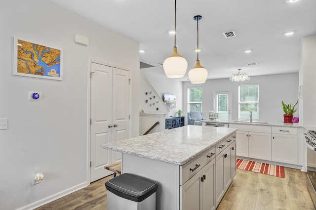 136 Rowans Creek Dr, Charleston, SC 29492 - kitchen featuring light wood-style floors, a center island, recessed lighting, hanging light fixtures, and light stone countertops