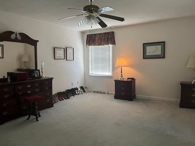 miscellaneous room featuring carpet floors, a textured ceiling, and ceiling fan