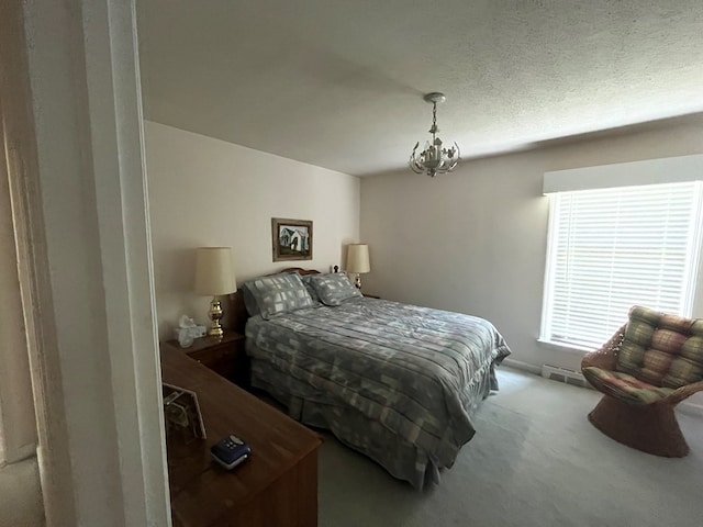 bedroom featuring an inviting chandelier and carpet flooring