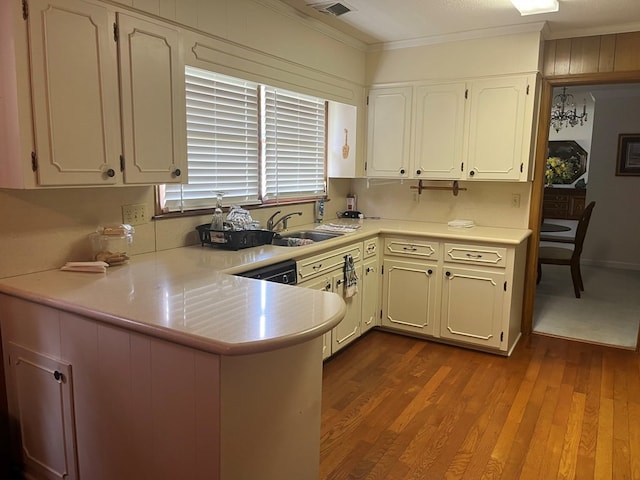 kitchen with kitchen peninsula, crown molding, white cabinets, and light hardwood / wood-style flooring