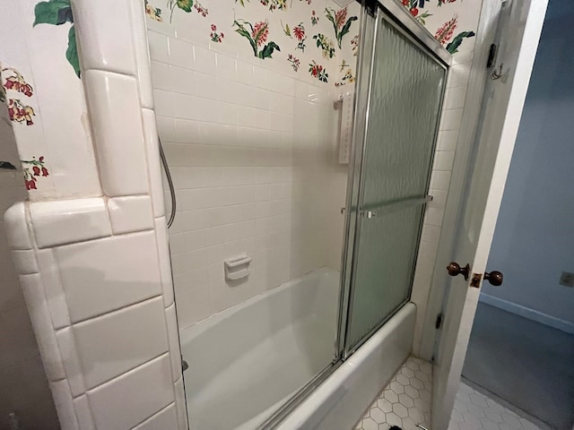 bathroom with shower / bath combination with glass door and tile patterned floors