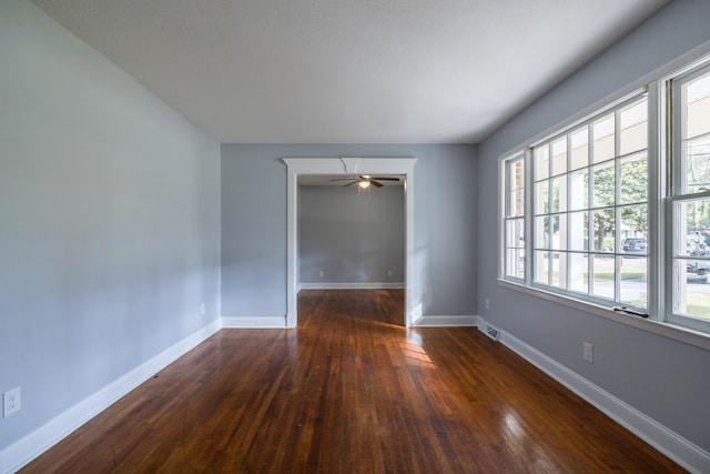 empty room featuring ceiling fan and dark hardwood / wood-style flooring