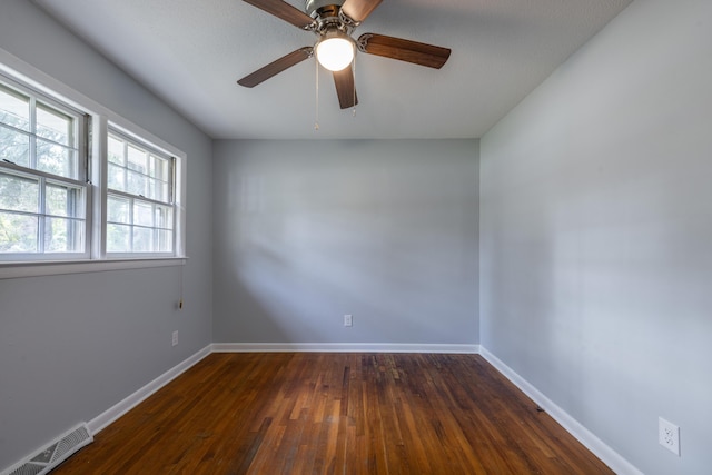 unfurnished room with ceiling fan and dark wood-type flooring