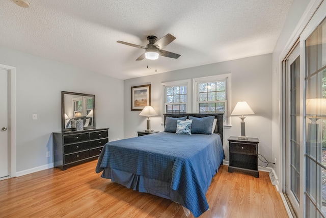 bedroom with wood-type flooring, a textured ceiling, and ceiling fan