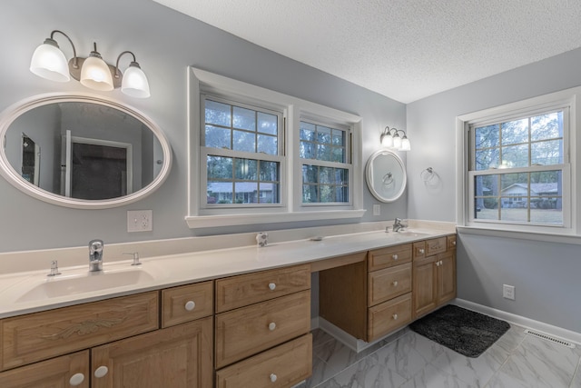 bathroom with vanity and a textured ceiling