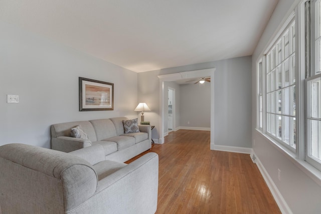 living room with ceiling fan and light wood-type flooring