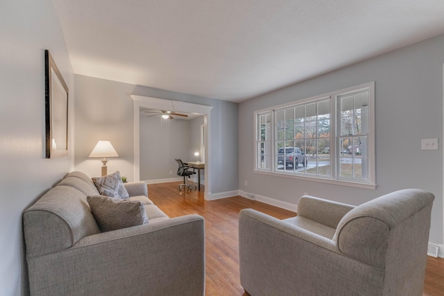 living room with ceiling fan and hardwood / wood-style floors