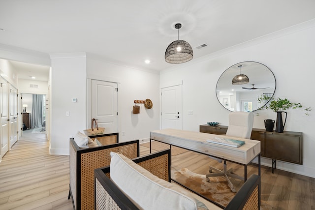 office area featuring ceiling fan, crown molding, and light hardwood / wood-style floors