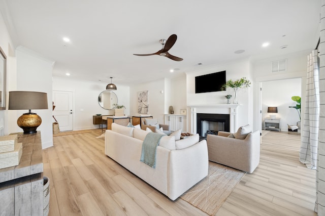 living room with ceiling fan and light hardwood / wood-style flooring