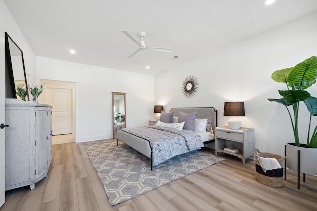 bedroom with ceiling fan and light hardwood / wood-style flooring