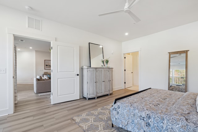 bedroom with light hardwood / wood-style floors and ceiling fan