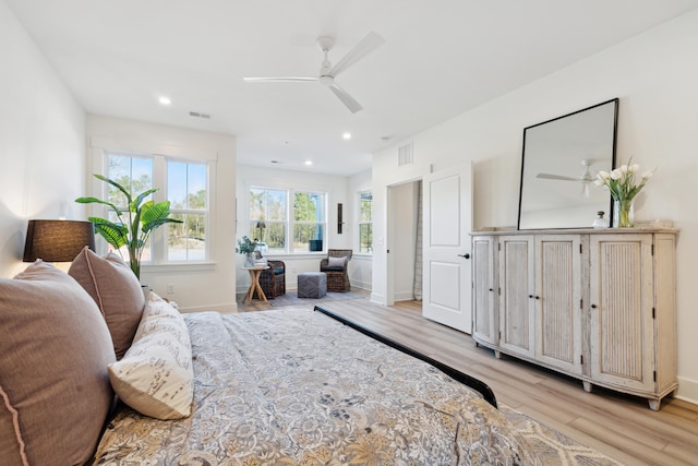 bedroom with ceiling fan and light hardwood / wood-style flooring