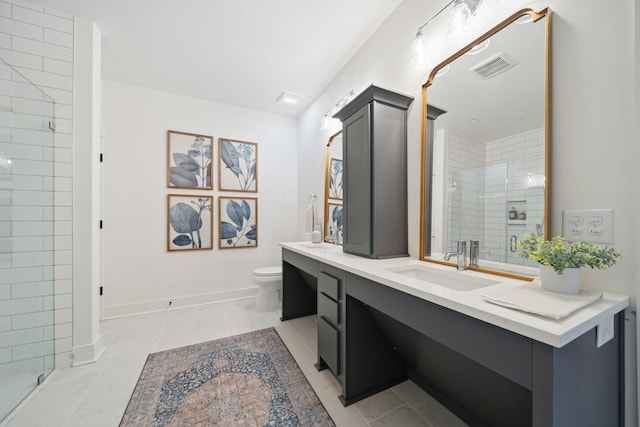 bathroom with vanity, toilet, a shower with door, and tile patterned floors