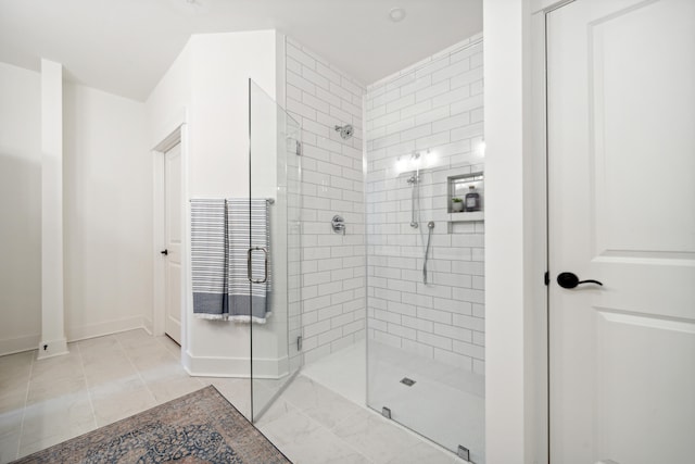 bathroom featuring tile patterned flooring and a shower with shower door