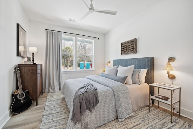 bedroom with light hardwood / wood-style floors and ceiling fan