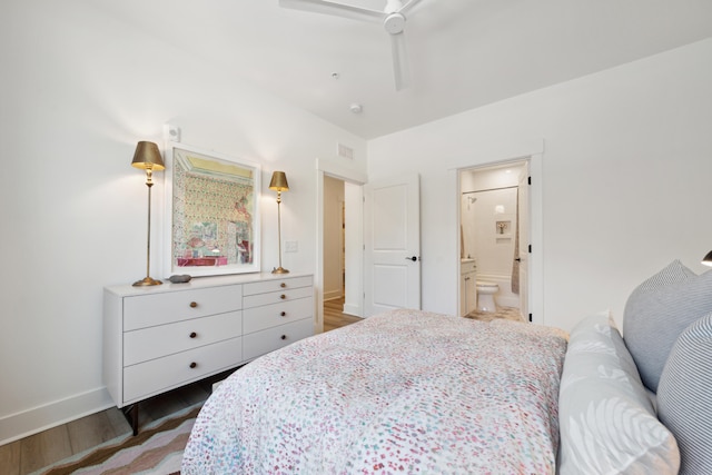 bedroom featuring ensuite bath, ceiling fan, and dark wood-type flooring