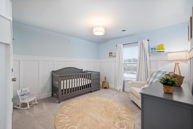 carpeted bedroom with a crib