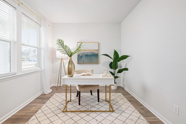 home office with dark hardwood / wood-style floors