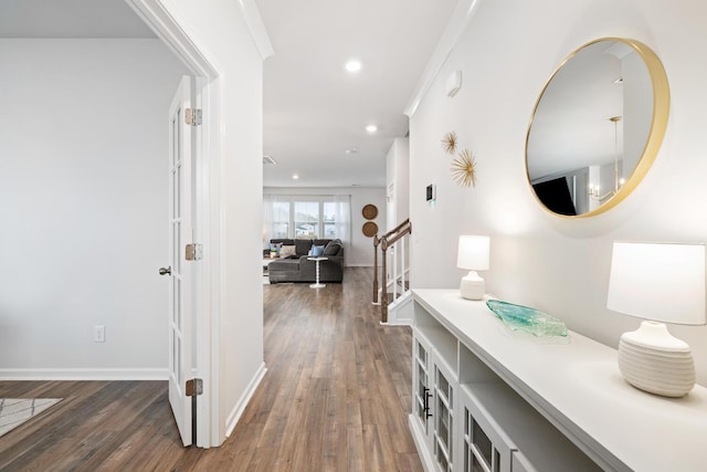 hall featuring crown molding and dark hardwood / wood-style flooring