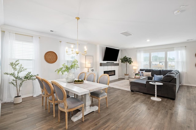 dining area featuring dark wood-type flooring and a chandelier