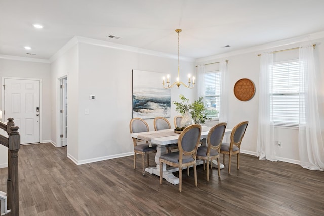 dining space featuring dark wood-type flooring, ornamental molding, and a chandelier