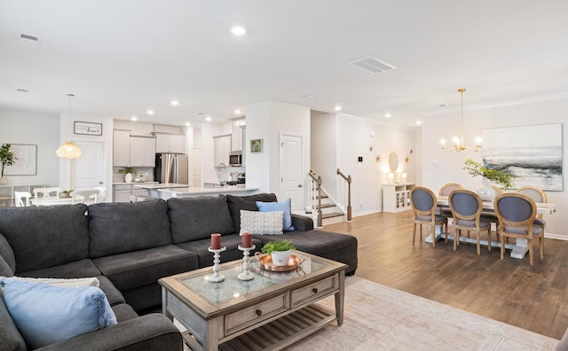 living room with light hardwood / wood-style flooring and a chandelier