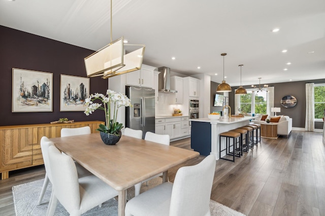 dining area with dark wood finished floors, recessed lighting, and baseboards