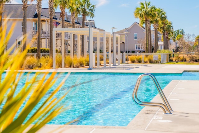 community pool with fence and a residential view