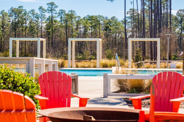 outdoor pool featuring view of scattered trees
