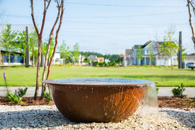 view of green lawn with a residential view